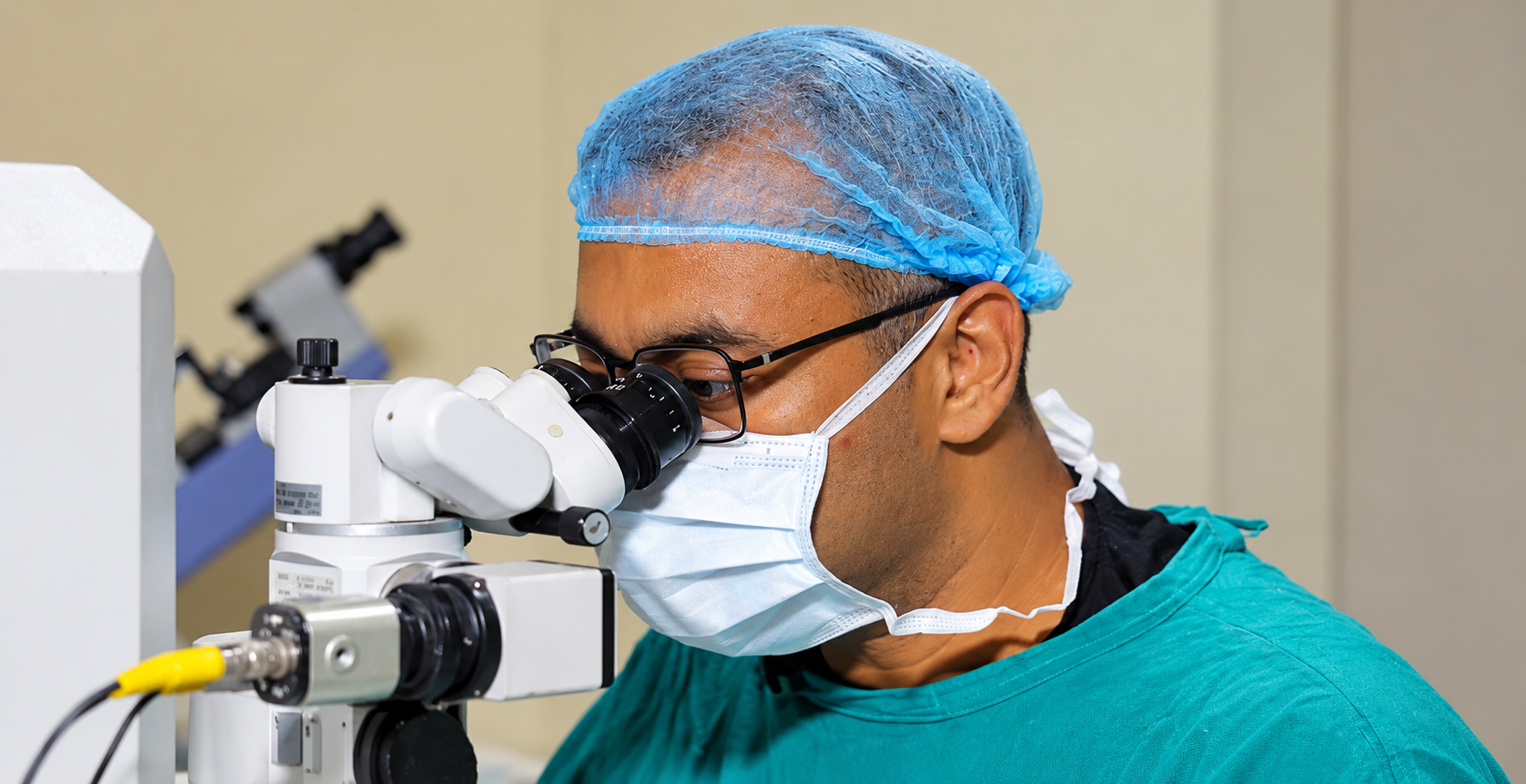 Surgeon using an operating microscope in a clinical theatre